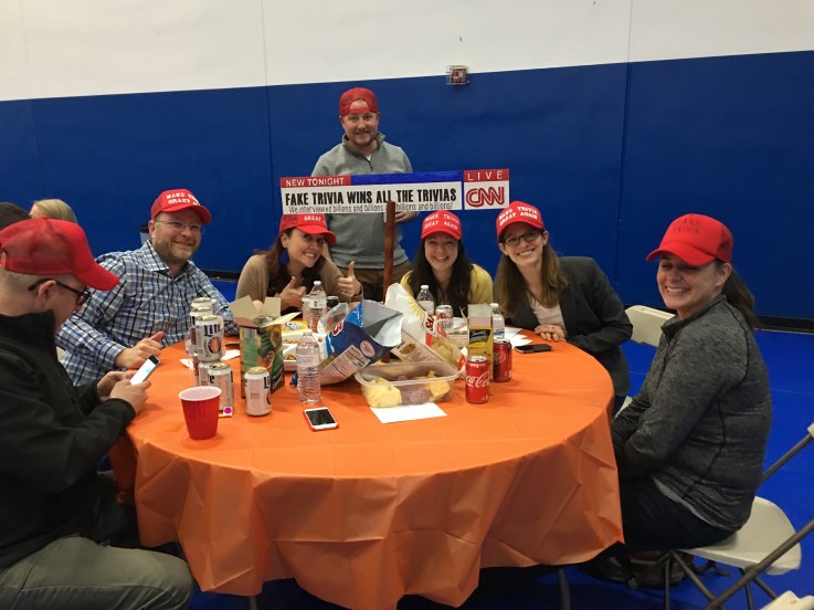 A group of people sitting around a table.