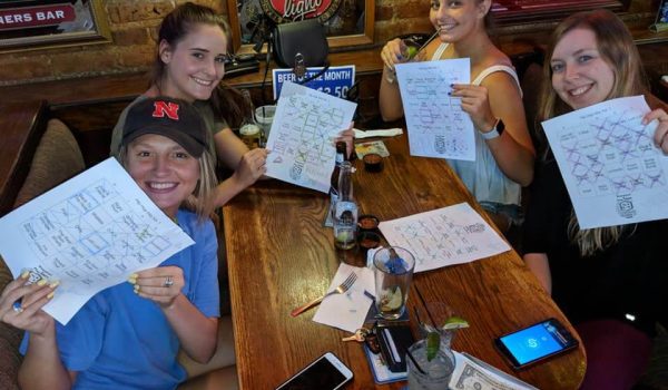 A group of people sitting at a table holding papers.